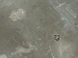 a picture of a dirty metal surface with a hole in it