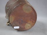 a brown vase sitting on top of a white table