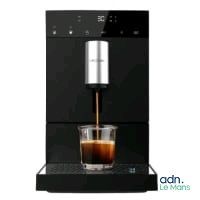 an image of a coffee machine with a cup of coffee in it