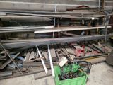 many pieces of metal in a green container in a garage