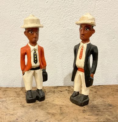 two figurines of a man and a woman standing next to each other