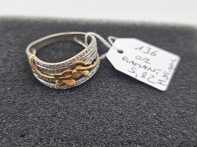 a close up of a silver and gold ring with a price tag