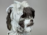 a white and black dog figurine sitting on a table