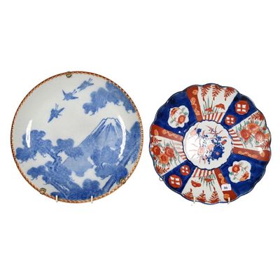 two blue and white plates with designs on them on a white surface
