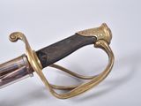 a close up of a sword on a white surface