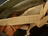 a close up of a helmet with a tie on it