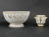 three white and gold vases sitting next to each other on a table