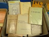 many books in a box on a table