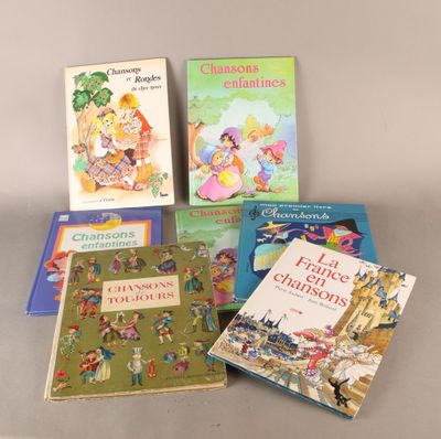several children ' s books are lined up on a table