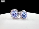 pair of tanzane and diamond earrings on a white plate