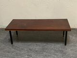 a brown table with black legs and a brown table top