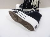 a pair of black and white sneakers on a white surface