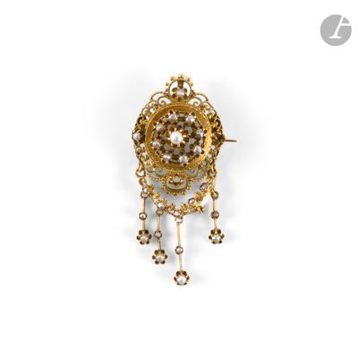 a close up of a gold and diamond broochle on a white background