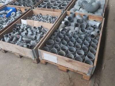 des cartons contenant des tuyaux et des raccords de différentes tailles et formes dans un entrepôt