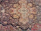 an antique persian rug with a medallion design on a blue ground