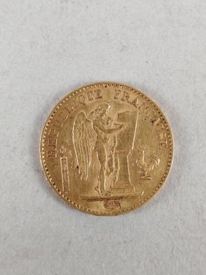 a close up of a gold coin on a white surface