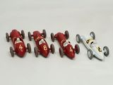 several toy cars are lined up in a row on a white surface