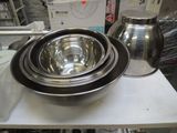 a metal bowl and a metal jug on a table