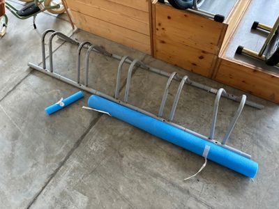a bike rack that has a blue tube attached to it