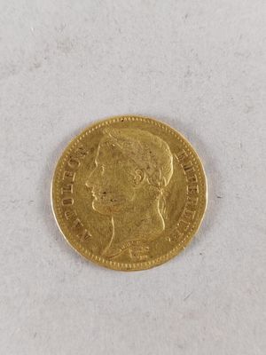 a close up of a gold coin on a white surface