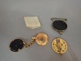 three different types of gold and black jewelry on a table