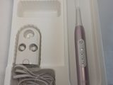 a white box with a pink electric toothbrush in it
