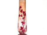 a glass vase with red flowers on it