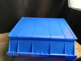 a blue plastic container sitting on top of a wooden table