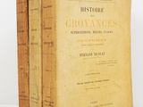 three old books sitting on top of each other on a table