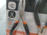 two pairs of pliers in a package on a table