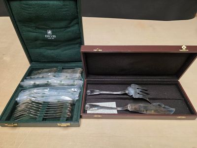 a lot of silverware in a case on a table