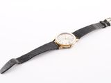 an image of a close up of a wrist watch on a white surface