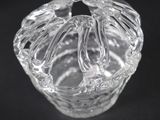 a close up of a glass vase on a black surface