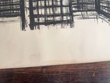 a black and white drawing on a piece of paper on a table