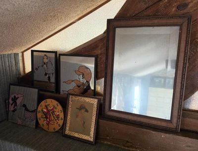 many pictures on a shelf with a mirror on top of it