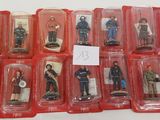 many figurines of different types of people in plastic cases