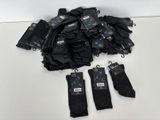black umbrellas with tags on them sitting on a white table