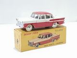a red and white toy car sitting on top of a box