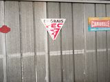 a fire hydrant in the corner of a garage with signs on the wall