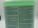 a close up of a bottle of liquid on a white surface