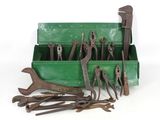 many tools in a green box on a white surface