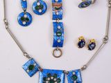 an image of a necklace and earring set on a white surface