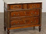 an image of a marble top chest of drawers on a parquet floor