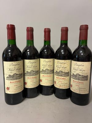 six bottles of wine are lined up on a table