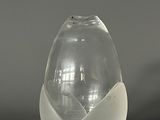 a glass vase with a white flower inside of it