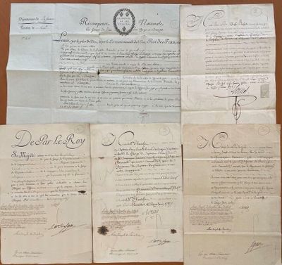 some old papers are sitting on a table with a pen and ink
