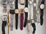 many different types of watches displayed in a box