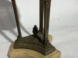 an image of a statue of a man holding a baseball bat on a marble base