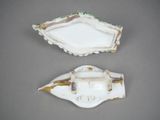 two pieces of porcelain are shown on a gray surface