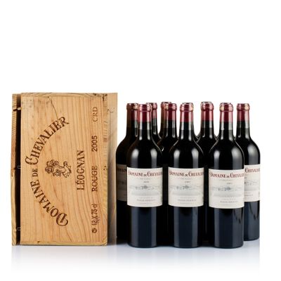 six bottles of red wine in a wooden box next to a wooden box